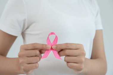 Woman hold pink ribbon breast cancer awareness. Female health check consciousness. international Women Day and World Cancer Day. sign cancer, Symbolic, health care, support patients, timely diagnosis