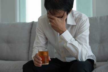 Depresyondaki genç iş adamı evde yalnız başına viski içmenin kötü hissettirdiğini vurguladı alkol içmek sorunlu içki, alkolizm, hayat ve aile sorunlarından muzdarip.