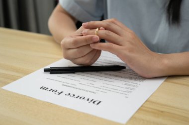 Divorce. Woman remove married ring. Couples desperate and disappointed after marriage. Husband wife sad, upset and frustrated after quarrels conflict. distrust, love problems, betrayals, family, lover