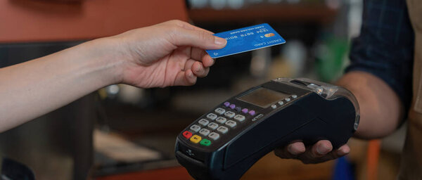 Woman use credit card pay money online in cafe restaurant with a digital payment without cash. accumulate discount. E wallet, technology, pay online, credit card, bank app. daily life payment