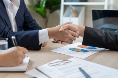 Executives are shaking hand after results success to target. financial data analysis and market growth report chart. Planning Strategies, startup project, profitable strategy, Business meeting time