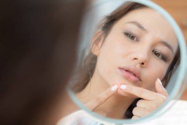 Woman worried about face Dermatology, rosacea dermatitis, allergic steroids, sensitive skin, red face from sunburn, acne, dry skin, large pores ,rash face, dull, freckles, wrinkle, skin problem, beauty