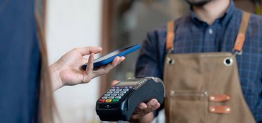 Woman use smartphone to scan QR code to pay in cafe restaurant with a digital payment without cash. Choose menu and order accumulate discount. E wallet, technology, pay online, credit card, bank app.