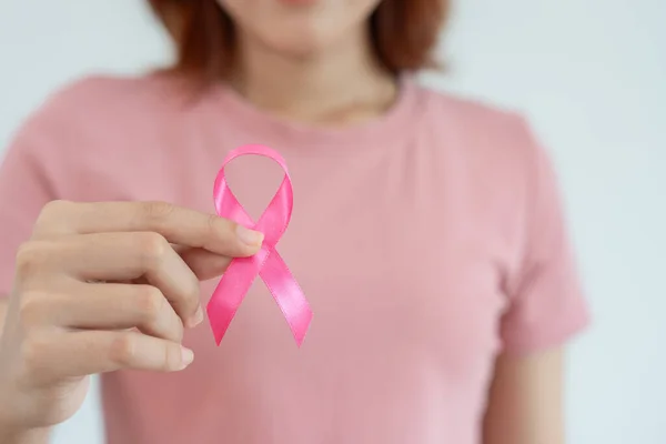 Woman hold pink ribbon breast cancer awareness. Female health check consciousness. international Women Day and World Cancer Day. sign cancer, Symbolic, health care, support patients, timely diagnosis
