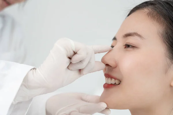 plastic surgery, beauty asian smile and happy after surgery, surgical procedure that involve altering shape of nose, doctor examines patient nose before rhinoplasty, medical assistance, healt