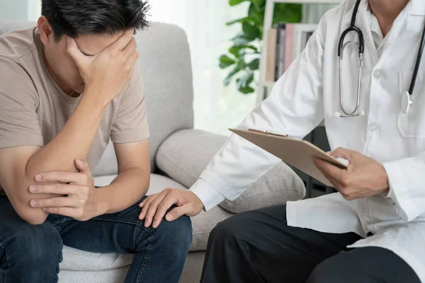 stock image man with mental health problems is consulting. psychiatrist is recording the patient's condition for treatment. encouragement, love and family problem, bipolar , depression patient, protect suicide