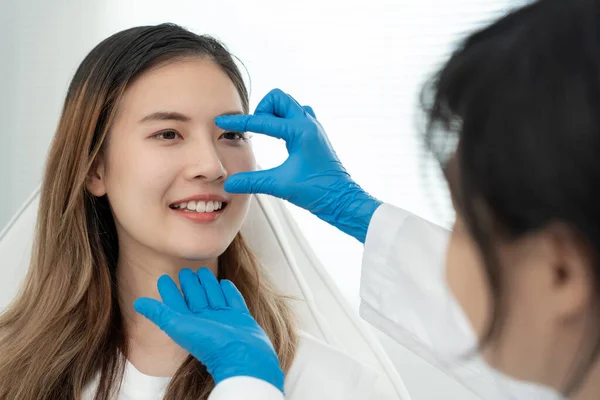 plastic surgery, beauty, Surgeon or beautician touching woman face, surgical procedure that involve altering shape of nose, doctor examines patient nose before rhinoplasty, medical assistance, health