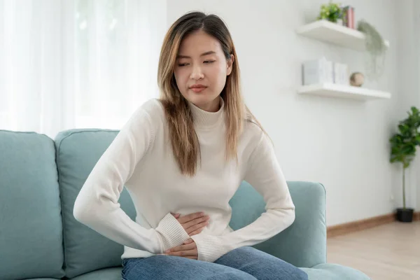 stomach ache. Asian women have abdominal pain, indigestion, gastritis, menstrual cramps, flatulence, diarrhea, distention, colon cancer, belly inflammation problem, suffer food poisoning, abdome