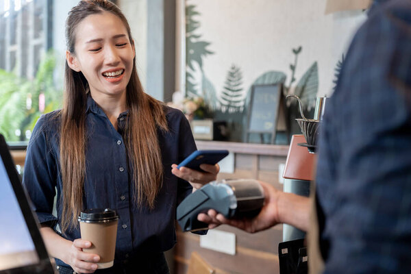 Woman use smartphone to scan QR code to pay in cafe restaurant with a digital payment without cash. Choose menu and order accumulate discount. E wallet, technology, pay online, credit card, bank app.