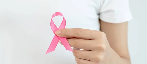 Woman hold pink ribbon breast cancer awareness. Female health check consciousness. international Women Day and World Cancer Day. sign cancer, Symbolic, health care, support patients, timely diagnosi