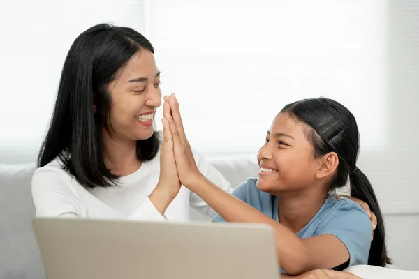Mother teaching lesson for daughter. Asian young little girl learn at home. Do homework with kind mother help, encourage for exam.. Girl happy Homeschool. Mom advice education together.