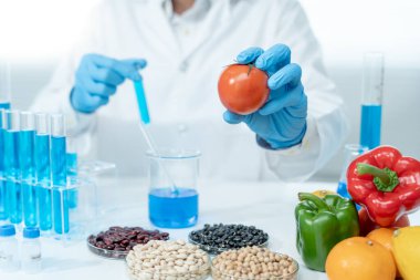 Scientist check chemical food residues in laboratory. Control experts inspect quality of fruits, vegetables. lab, hazards, ROHs, find prohibited substances, contaminate, Microscope, Microbiologist