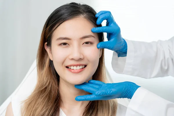 Cosmetic surgery, beauty, Surgeon or beautician touching woman face, surgical procedure that involve altering shape of eye, medical assistance, eyelid surgery, double eyelid, big eyes, ptosis