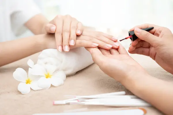 Woman receive care service by professional Beautician Manicure at spa centre. Nail beauty salon use nail file for Glazing treatment. manicurist make nail customer to beautiful. body care spa treatment