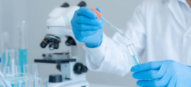 Scientist analyze biochemical samples in advanced scientific laboratory. Medical professional use dropper mix microbiological developmental of viral. Biotechnology research in  science lab. cosmetic