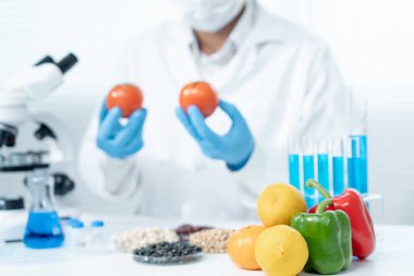 Scientist check chemical food residues in laboratory. Control experts inspect quality of fruits, vegetables. lab, hazards, ROHs, find prohibited substances, contaminate, Microscope, Microbiologist