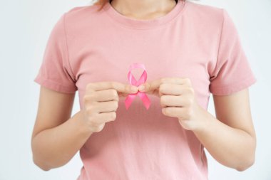 Woman hold pink ribbon breast cancer awareness. Female health check consciousness. international Women Day and World Cancer Day. sign cancer, Symbolic, health care, support patients, timely diagnosis