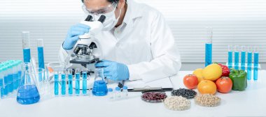 Scientist check chemical food residues in laboratory. Control experts inspect quality of fruits, vegetables. lab, hazards, ROHs, find prohibited substances, contaminate, Microscope, Microbiologist