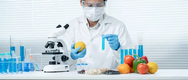 Scientist check chemical food residues in laboratory. Control experts inspect quality of fruits, vegetables. lab, hazards, ROHs, find prohibited substances, contaminate, Microscope, Microbiologis