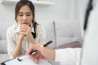 Akıl sağlığı sorunları olan bir kadın danışmanlık yapıyor. Psikiyatrist tedavi için hastanın durumunu kaydediyor. teşvik, sevgi ve aile sorunu, bipolar, depresyon hastası, intiharı koru