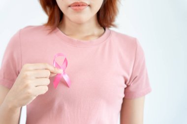 Woman hold pink ribbon breast cancer awareness. Female health check consciousness. international Women Day and World Cancer Day. sign cancer, Symbolic, health care, support patients, timely diagnosis