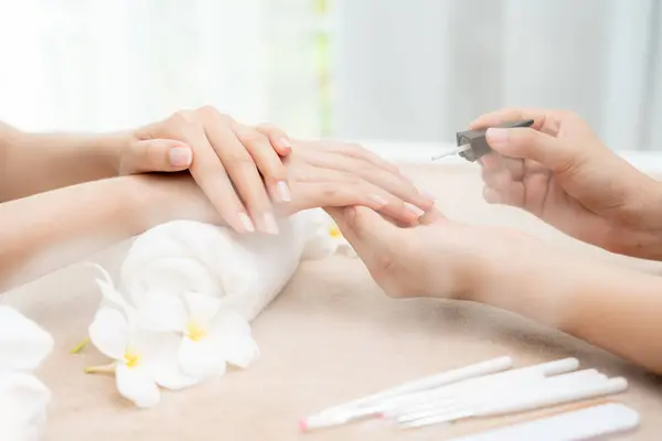 Woman receive care service by professional Beautician Manicure at spa centre. Nail beauty salon use nail file for Glazing treatment. manicurist make nail customer to beautiful. body care spa treatment