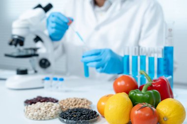 Scientist check chemical food residues in laboratory. Control experts inspect quality of fruits, vegetables. lab, hazards, ROHs, find prohibited substances, contaminate, Microscope, Microbiologist