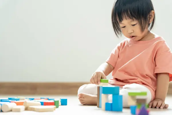 Happy Asian child playing and learning toy blocks. children are very happy and excited at home. child have a great time playing, activities, development, attention deficit hyperactivity disorder