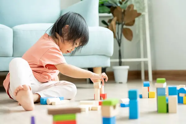 Happy Asian child playing and learning toy blocks. children are very happy and excited at home. child have a great time playing, activities, development, attention deficit hyperactivity disorde