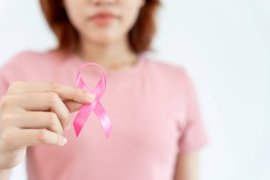 Woman hold pink ribbon breast cancer awareness. Female health check consciousness. international Women Day and World Cancer Day. sign cancer, Symbolic, health care, support patients, timely diagnosis