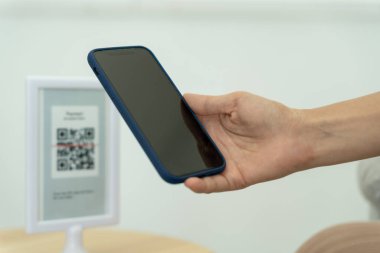 Woman use smartphone to scan QR code to pay in cafe restaurant with a digital payment without cash. Choose menu and order accumulate discount. E wallet, technology, pay online, credit card, bank app.