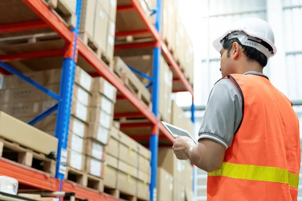 Asian male factory manager inspect goods in warehouse or inventory and check stock product. Transport logistic business shipping, delivery to customers. inspection, storehouse, storage, factory