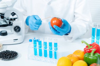 Scientist check chemical food residues in laboratory. Control experts inspect quality of fruits, vegetables. lab, hazards, ROHs, find prohibited substances, contaminate, Microscope, Microbiologist