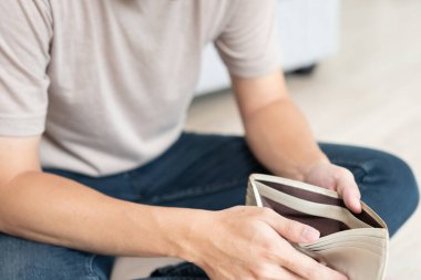 Stressed and headache man with large bills or invoices no money to pay to expenses and credit card debt. shortage, Financial problem, bankruptcy, mortgage, loan, bankrupt, poor, empty wallet 