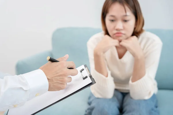 woman with mental health problems is consulting. psychiatrist is recording the patient\'s condition for treatment. encouragement, love and family problem, bipolar , depression patient, protect suicide