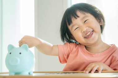 Save money. children putting coin for saving. wealth, Finance, insurance, investment, education, future, plan life, learn, banking, family, health, health and accident insurance.