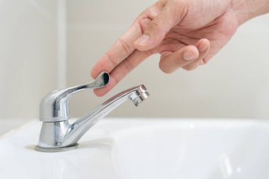 Save water. Volunteer keeps turning off the running water in the bathroom to protect environment. Greening planet, reduce global warming, Save world, life, future, risk energy, crisis , water day