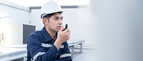 Asian maintenance engineer working on color background, contractor inspect compressor system and plans installation of air condition systems in construction. technology, walky talky, maintenance