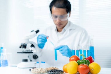 Scientist check chemical food residues in laboratory. Control experts inspect quality of fruits, vegetables. lab, hazards, ROHs, find prohibited substances, contaminate, Microscope, Microbiologist