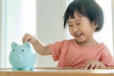 Save money. children putting coin for saving. wealth, Finance, insurance, investment, education, future, plan life, learn, banking, family, health, health and accident insurance.