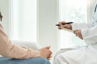 Akıl sağlığı sorunları olan bir kadın danışmanlık yapıyor. Psikiyatrist tedavi için hastanın durumunu kaydediyor. teşvik, sevgi ve aile sorunu, bipolar, depresyon hastası, intiharı koru