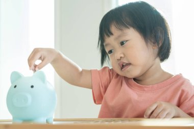 Save money. children putting coin for saving. wealth, Finance, insurance, investment, education, future, plan life, learn, banking, family, health, health and accident insurance.