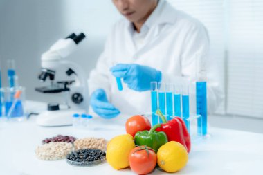Scientist check chemical food residues in laboratory. Control experts inspect quality of fruits, vegetables. lab, hazards, ROHs, find prohibited substances, contaminate, Microscope, Microbiologist
