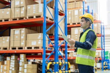 Asian male factory manager inspect goods in warehouse or inventory and check stock product. Transport logistic business shipping, delivery to customers. inspection, storehouse, storage, factory