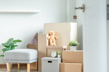 Moving house, relocation. The key was inserted into the door of the new house, inside the room was a cardboard box containing personal belongings and furniture. move in the apartment or condominium