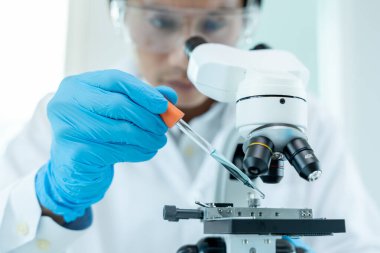 Scientist analyze biochemical samples in advanced scientific laboratory. Medical professional use dropper mix microbiological developmental of viral. Biotechnology research in  science lab. cosmetic