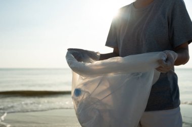 Save water. Volunteer pick up trash garbage at the beach and plastic bottles are difficult decompose prevent harm aquatic life. Earth, Environment, Greening planet, reduce global warming, Save worl