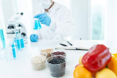 Scientist check chemical food residues in laboratory. Control experts inspect quality of fruits, vegetables. lab, hazards, ROHs, find prohibited substances, contaminate, Microscope, Microbiologist