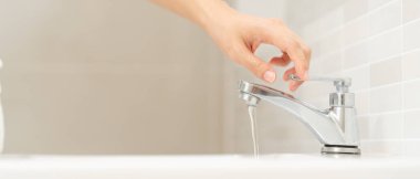Save water. Volunteer keeps turning off the running water in the bathroom to protect environment. Greening planet, reduce global warming, Save world, life, future, risk energy, crisis , water day.