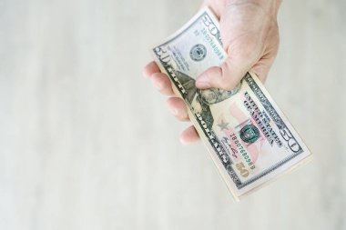 USD currency , Many dollar bank notes Placed on the table.The  Dollar is the currency of USA that is used to change, buy, sell, accumulate, and invest in united kingdom's state people.